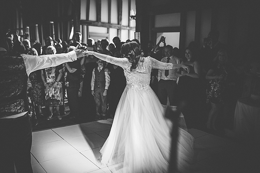 The bride wore a Watters wedding dress for her wedding at The Great Barn at Micklefield Hall in Hertfordshire. The bridesmaids wore navy blue. Photography by Benjamin Stuart.