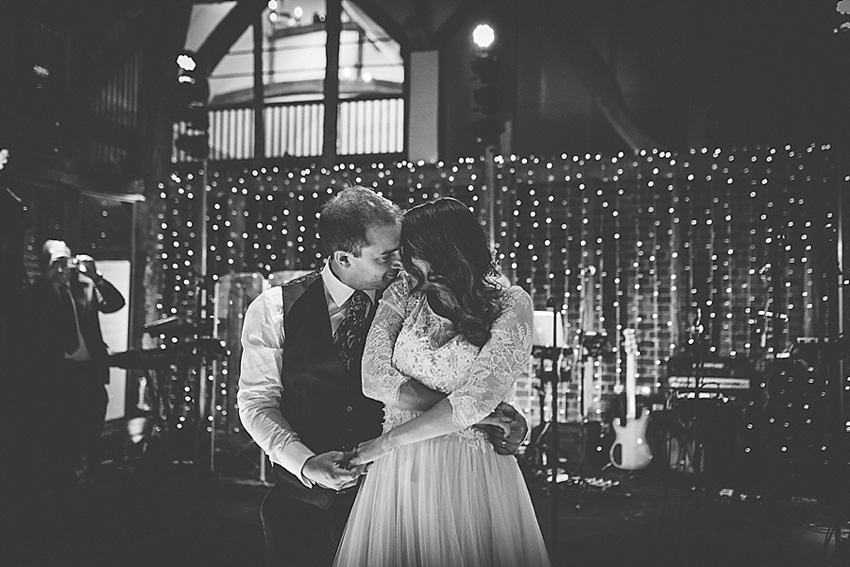 The bride wore a Watters wedding dress for her wedding at The Great Barn at Micklefield Hall in Hertfordshire. The bridesmaids wore navy blue. Photography by Benjamin Stuart.