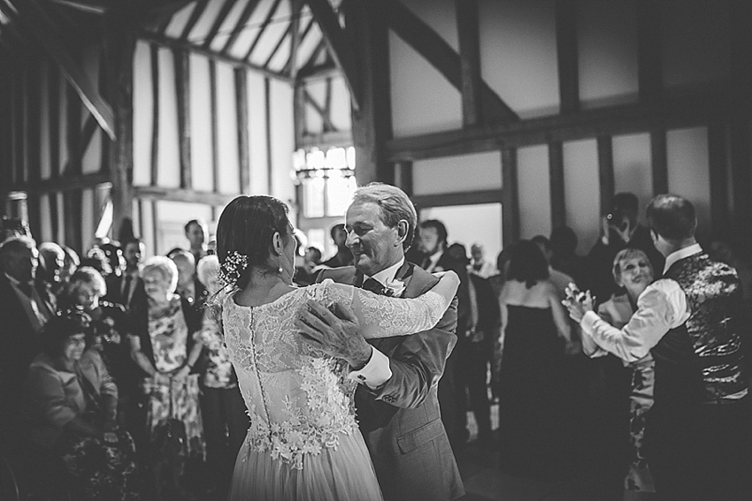 The bride wore a Watters wedding dress for her wedding at The Great Barn at Micklefield Hall in Hertfordshire. The bridesmaids wore navy blue. Photography by Benjamin Stuart.