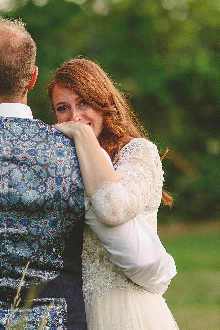 The bride wore a Watters wedding dress for her wedding at The Great Barn at Micklefield Hall in Hertfordshire. The bridesmaids wore navy blue. Photography by Benjamin Stuart.