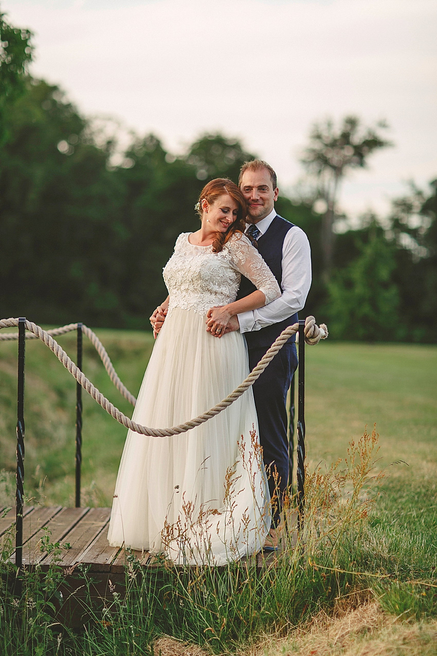 The bride wore a Watters wedding dress for her wedding at The Great Barn at Micklefield Hall in Hertfordshire. The bridesmaids wore navy blue. Photography by Benjamin Stuart.