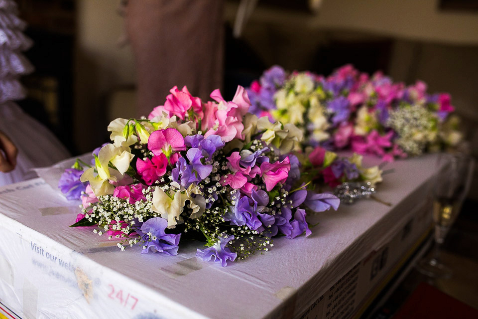 A blush pink wedding dress for a colourful and fun filled English country barn wedding. Photography by Jonny Draper.