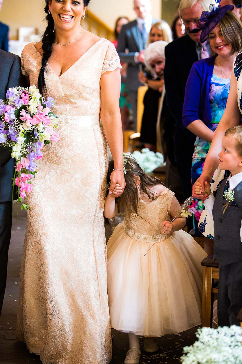 A blush pink wedding dress for a colourful and fun filled English country barn wedding. Photography by Jonny Draper.