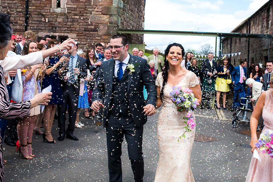 A blush pink wedding dress for a colourful and fun filled English country barn wedding. Photography by Jonny Draper.