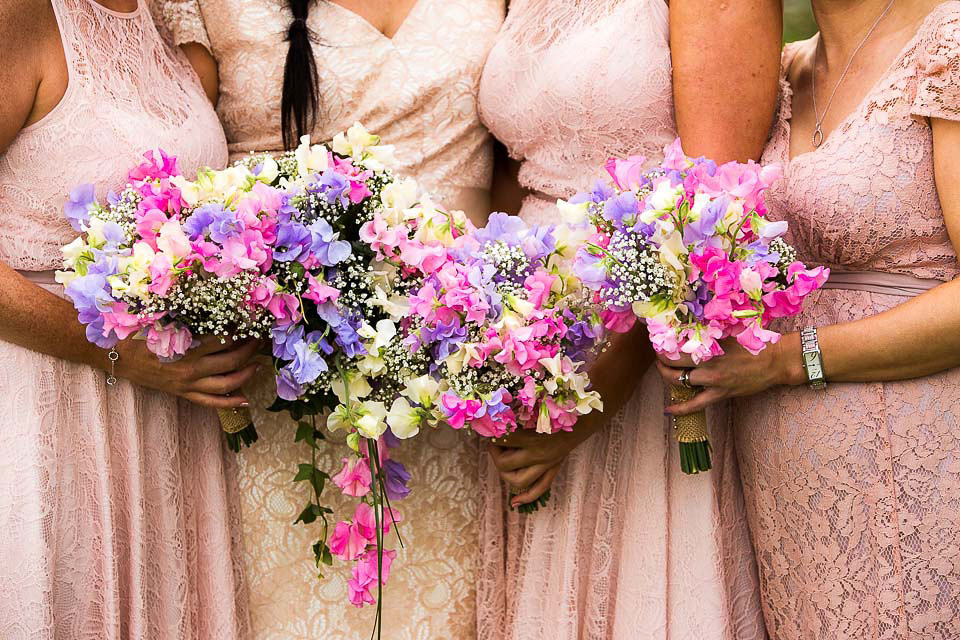 A blush pink wedding dress for a colourful and fun filled English country barn wedding. Photography by Jonny Draper.