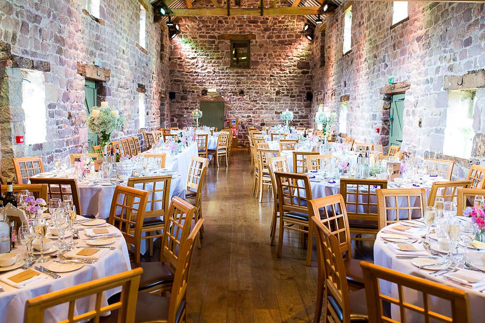 A blush pink wedding dress for a colourful and fun filled English country barn wedding. Photography by Jonny Draper.