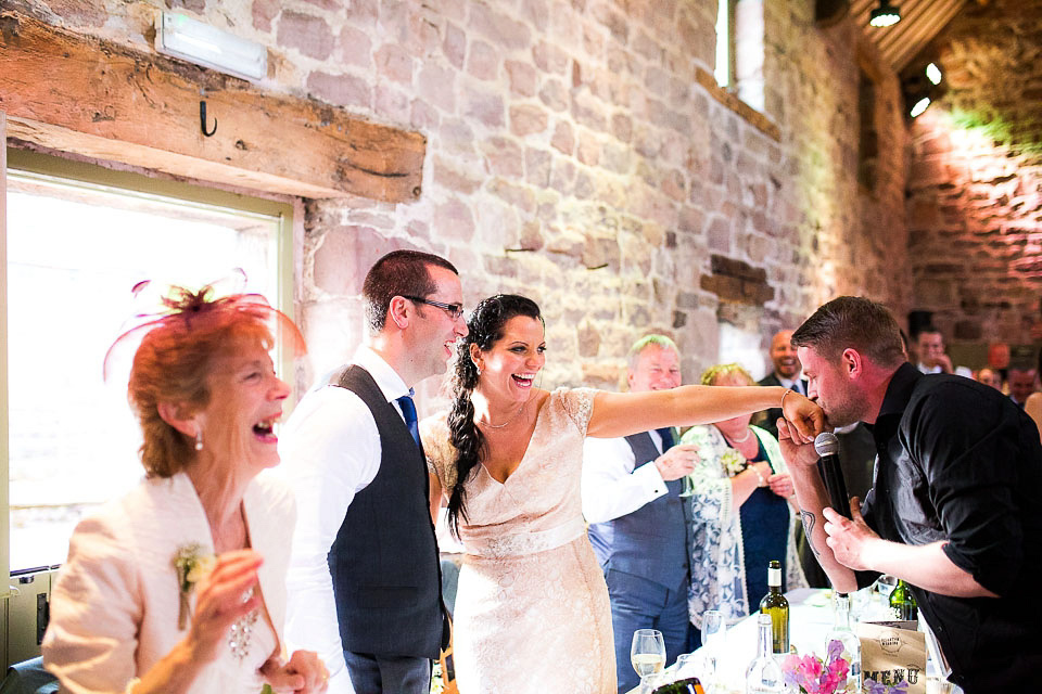 A blush pink wedding dress for a colourful and fun filled English country barn wedding. Photography by Jonny Draper.