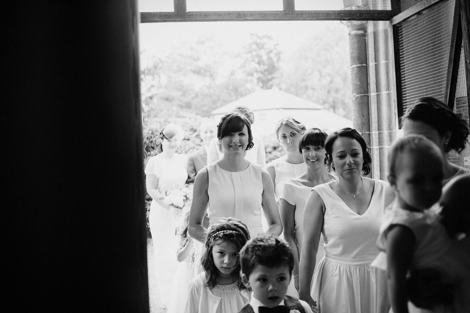 The bride wears Charlie Brear for her 'Railway Children' inspired yellow wedding. Photography by Claudia Rose Carter.