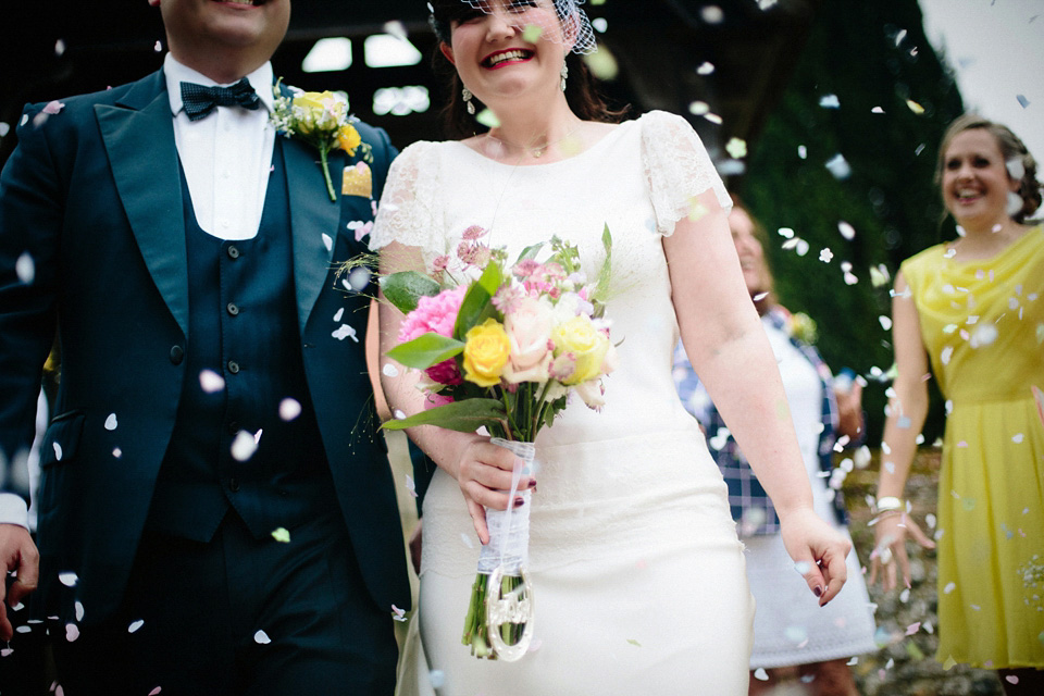 The bride wears Charlie Brear for her 'Railway Children' inspired yellow wedding. Photography by Claudia Rose Carter.