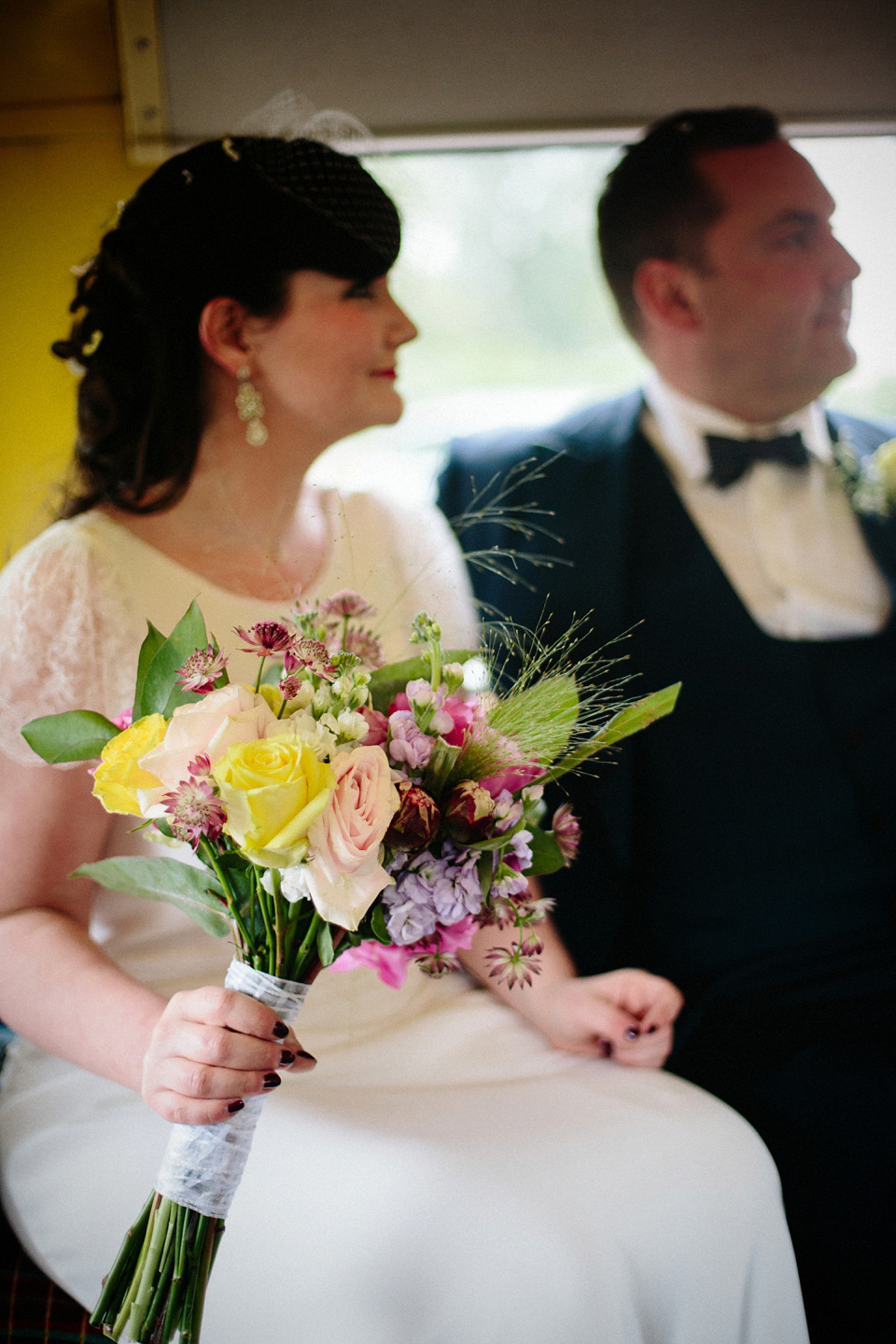 The bride wears Charlie Brear for her 'Railway Children' inspired yellow wedding. Photography by Claudia Rose Carter.