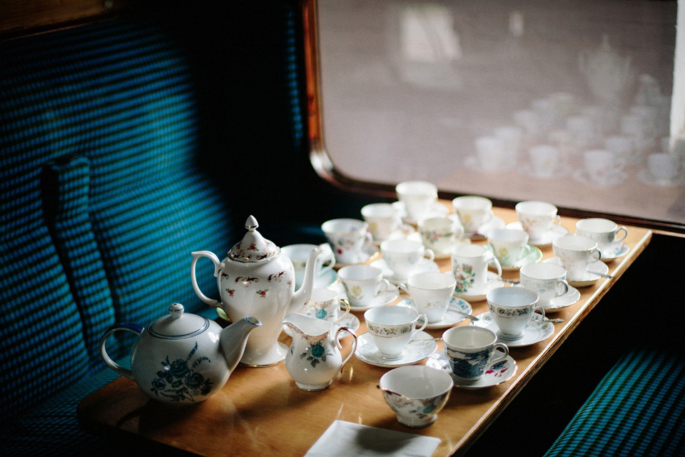 The bride wears Charlie Brear for her 'Railway Children' inspired yellow wedding. Photography by Claudia Rose Carter.