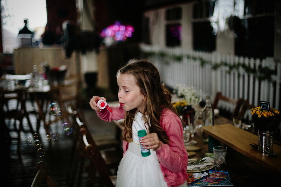 The bride wears Charlie Brear for her 'Railway Children' inspired yellow wedding. Photography by Claudia Rose Carter.