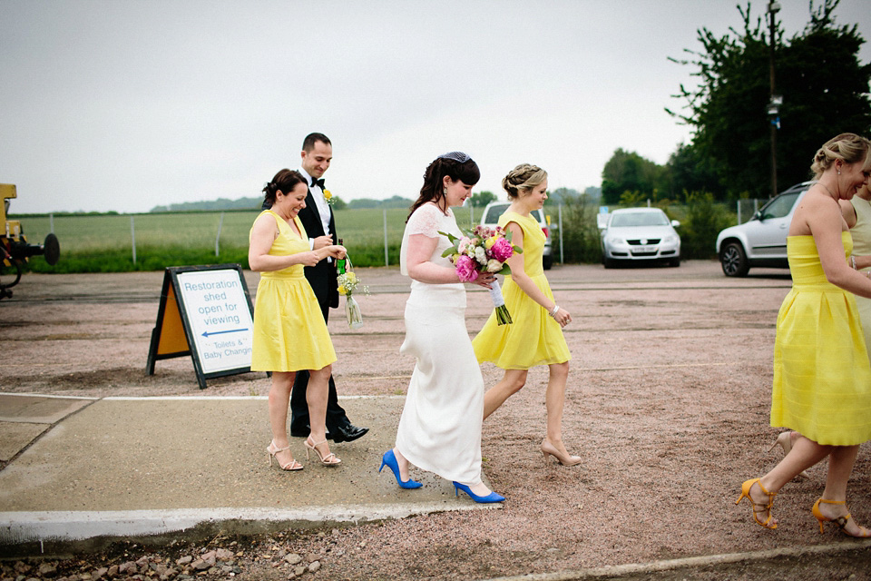 The bride wears Charlie Brear for her 'Railway Children' inspired yellow wedding. Photography by Claudia Rose Carter.