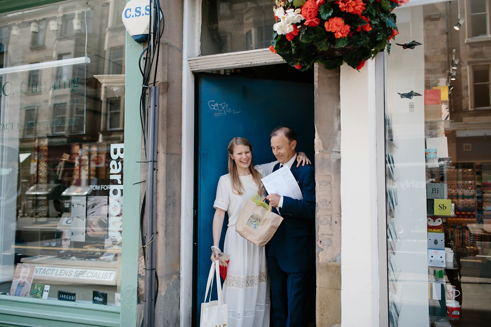 A Humanist handfasting outdoor ceremony at The Secret Herb Garden, just outside Edinburgh. The bride wore 'Minna'. Photography by Caro Weiss.