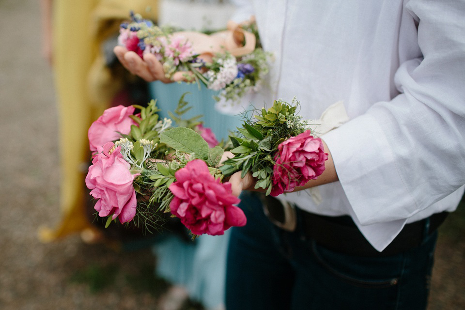 A Humanist handfasting outdoor ceremony at The Secret Herb Garden, just outside Edinburgh. The bride wore 'Minna'. Photography by Caro Weiss.