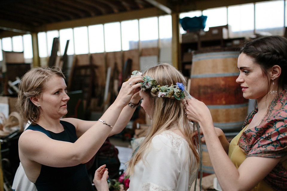 A Humanist handfasting outdoor ceremony at The Secret Herb Garden, just outside Edinburgh. The bride wore 'Minna'. Photography by Caro Weiss.