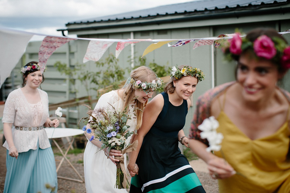 A Humanist handfasting outdoor ceremony at The Secret Herb Garden, just outside Edinburgh. The bride wore 'Minna'. Photography by Caro Weiss.