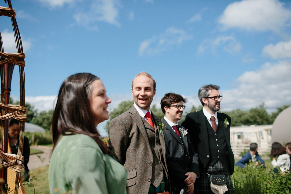 A Humanist handfasting outdoor ceremony at The Secret Herb Garden, just outside Edinburgh. The bride wore 'Minna'. Photography by Caro Weiss.