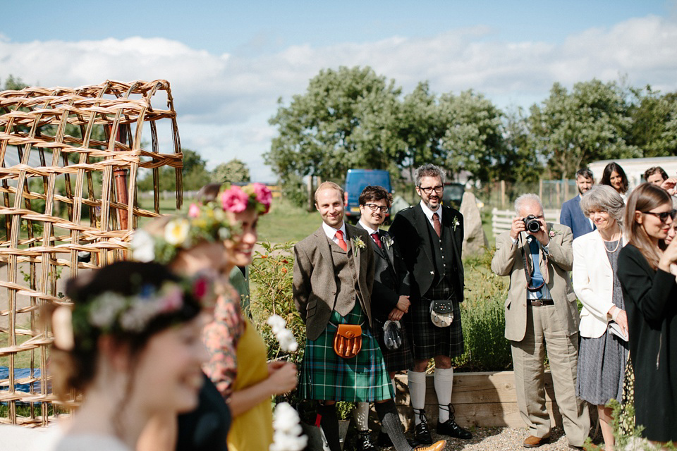 A Humanist handfasting outdoor ceremony at The Secret Herb Garden, just outside Edinburgh. The bride wore 'Minna'. Photography by Caro Weiss.