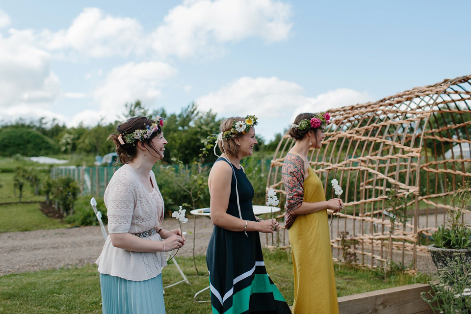 A Humanist handfasting outdoor ceremony at The Secret Herb Garden, just outside Edinburgh. The bride wore 'Minna'. Photography by Caro Weiss.