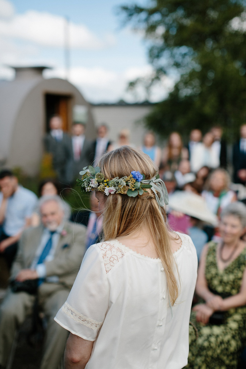 A Humanist handfasting outdoor ceremony at The Secret Herb Garden, just outside Edinburgh. The bride wore 'Minna'. Photography by Caro Weiss.