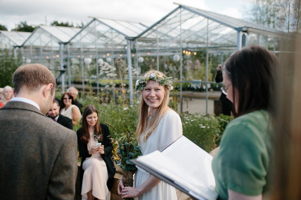 A Humanist handfasting outdoor ceremony at The Secret Herb Garden, just outside Edinburgh. The bride wore 'Minna'. Photography by Caro Weiss.