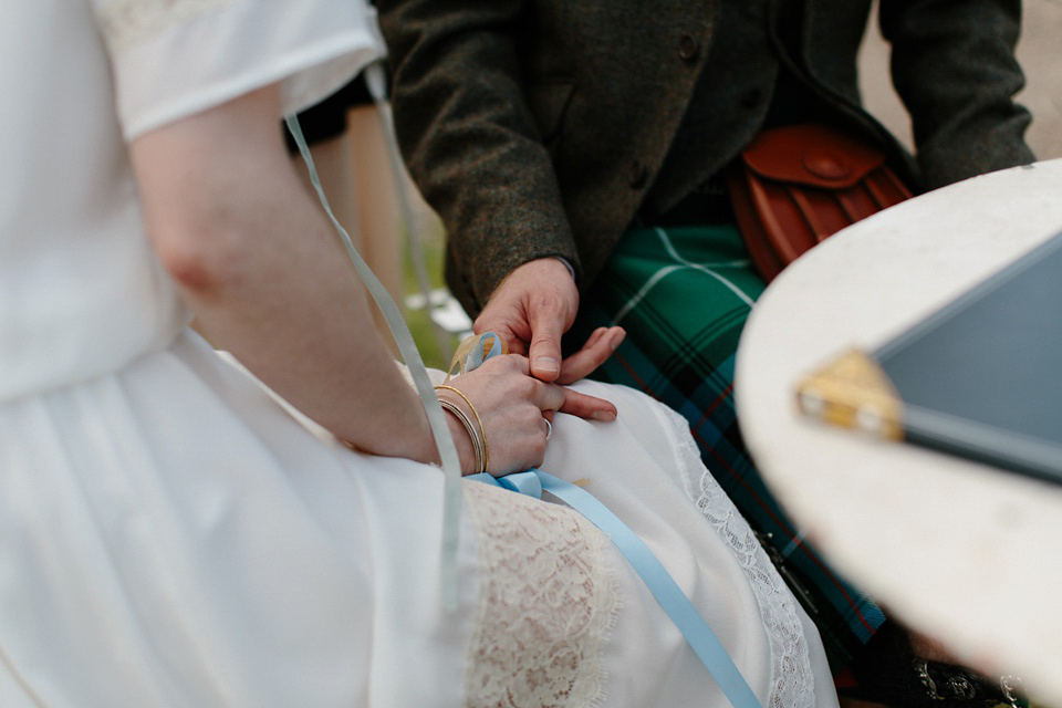A Humanist handfasting outdoor ceremony at The Secret Herb Garden, just outside Edinburgh. The bride wore 'Minna'. Photography by Caro Weiss.