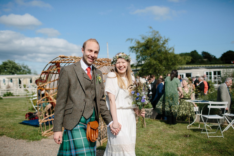 A Humanist handfasting outdoor ceremony at The Secret Herb Garden, just outside Edinburgh. The bride wore 'Minna'. Photography by Caro Weiss.