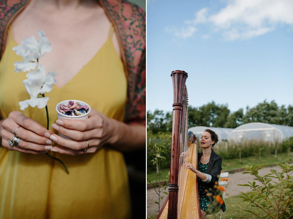 A Humanist handfasting outdoor ceremony at The Secret Herb Garden, just outside Edinburgh. The bride wore 'Minna'. Photography by Caro Weiss.