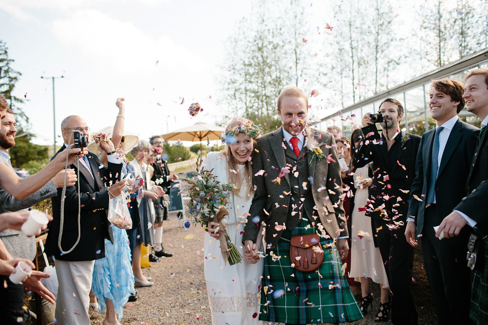 A Humanist handfasting outdoor ceremony at The Secret Herb Garden, just outside Edinburgh. The bride wore 'Minna'. Photography by Caro Weiss.