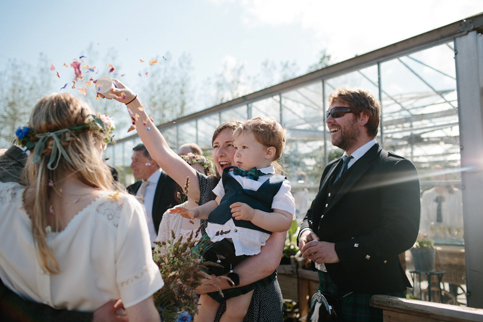 A Humanist handfasting outdoor ceremony at The Secret Herb Garden, just outside Edinburgh. The bride wore 'Minna'. Photography by Caro Weiss.