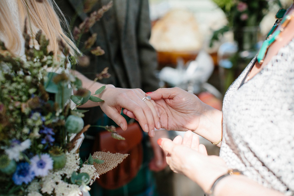 A Humanist handfasting outdoor ceremony at The Secret Herb Garden, just outside Edinburgh. The bride wore 'Minna'. Photography by Caro Weiss.