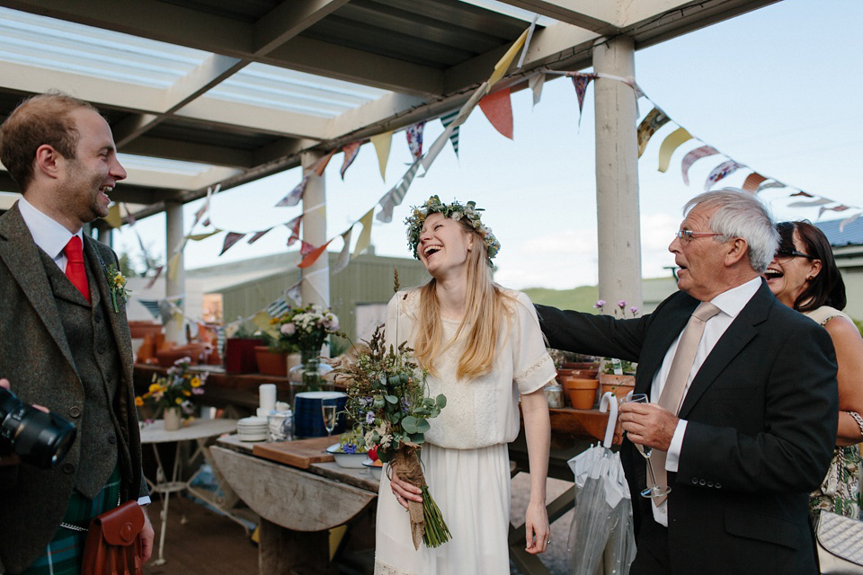 A Humanist handfasting outdoor ceremony at The Secret Herb Garden, just outside Edinburgh. The bride wore 'Minna'. Photography by Caro Weiss.