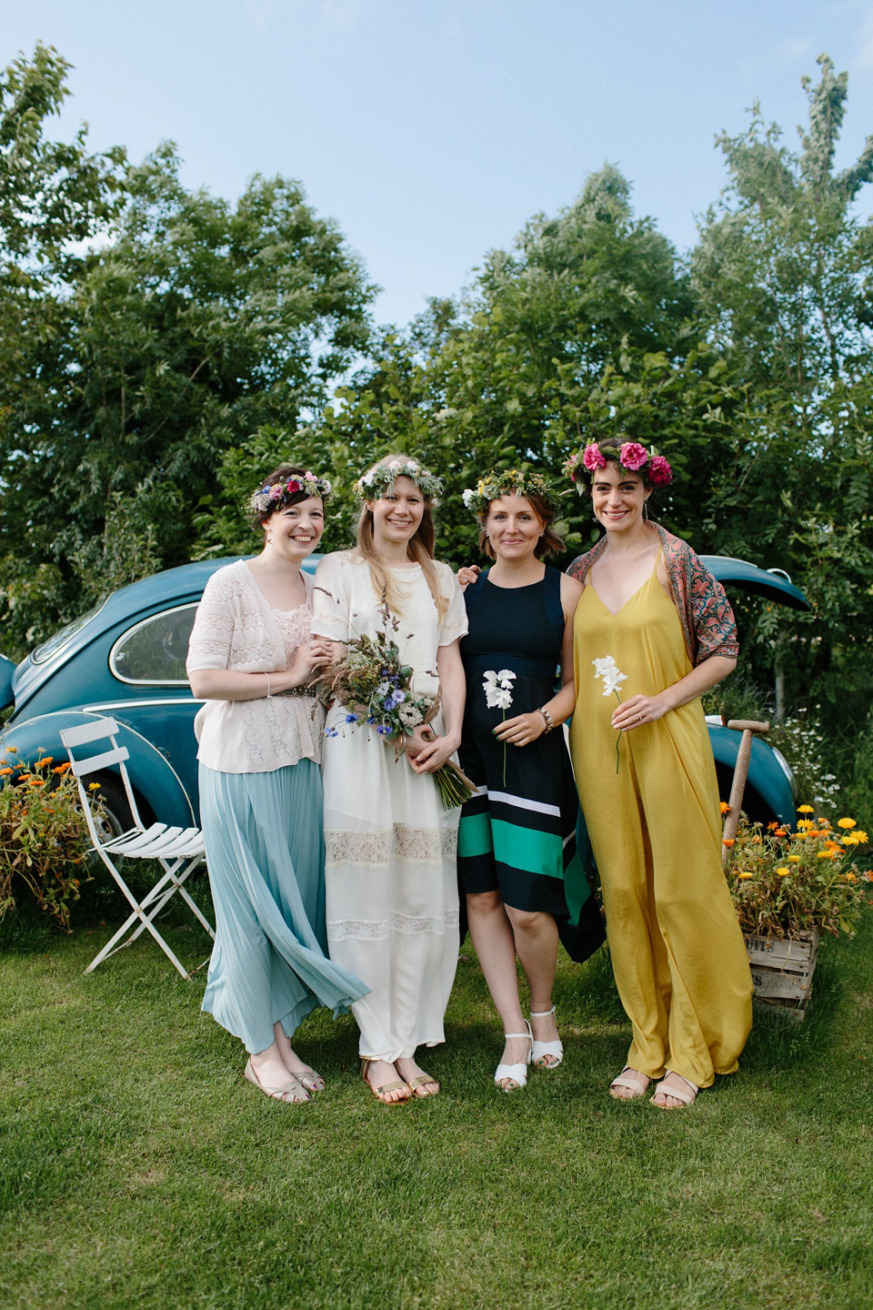 A Humanist handfasting outdoor ceremony at The Secret Herb Garden, just outside Edinburgh. The bride wore 'Minna'. Photography by Caro Weiss.