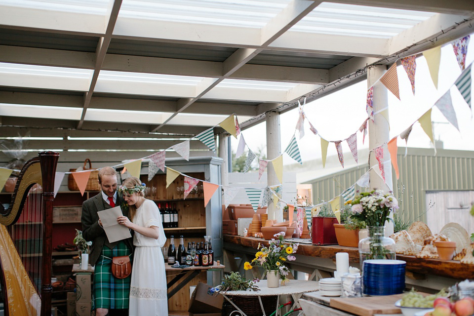 A Humanist handfasting outdoor ceremony at The Secret Herb Garden, just outside Edinburgh. The bride wore 'Minna'. Photography by Caro Weiss.