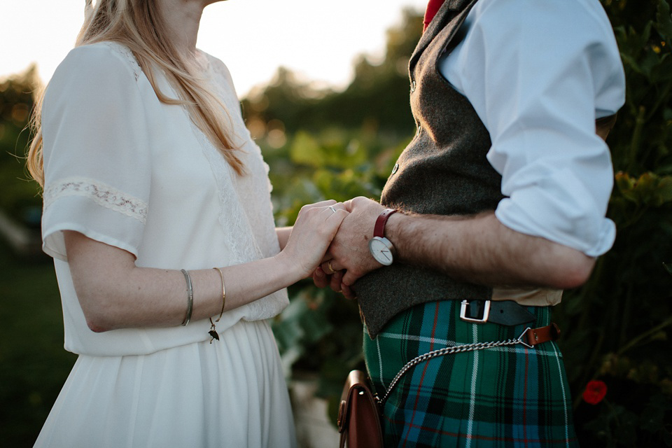 A Humanist handfasting outdoor ceremony at The Secret Herb Garden, just outside Edinburgh. The bride wore 'Minna'. Photography by Caro Weiss.