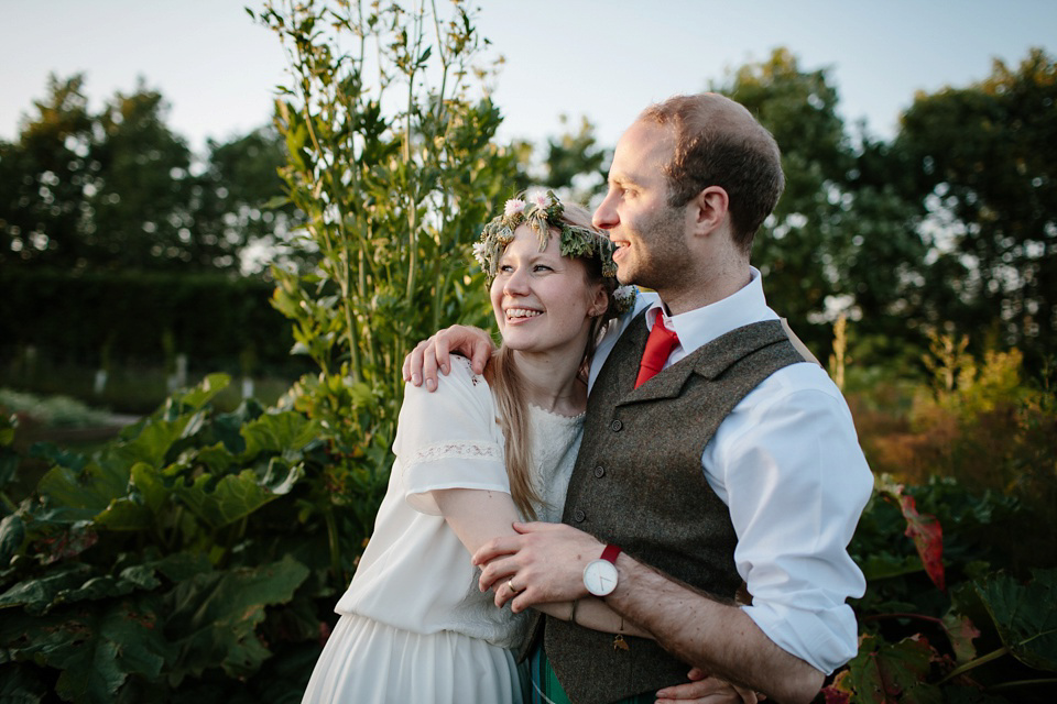 A Humanist handfasting outdoor ceremony at The Secret Herb Garden, just outside Edinburgh. The bride wore 'Minna'. Photography by Caro Weiss.