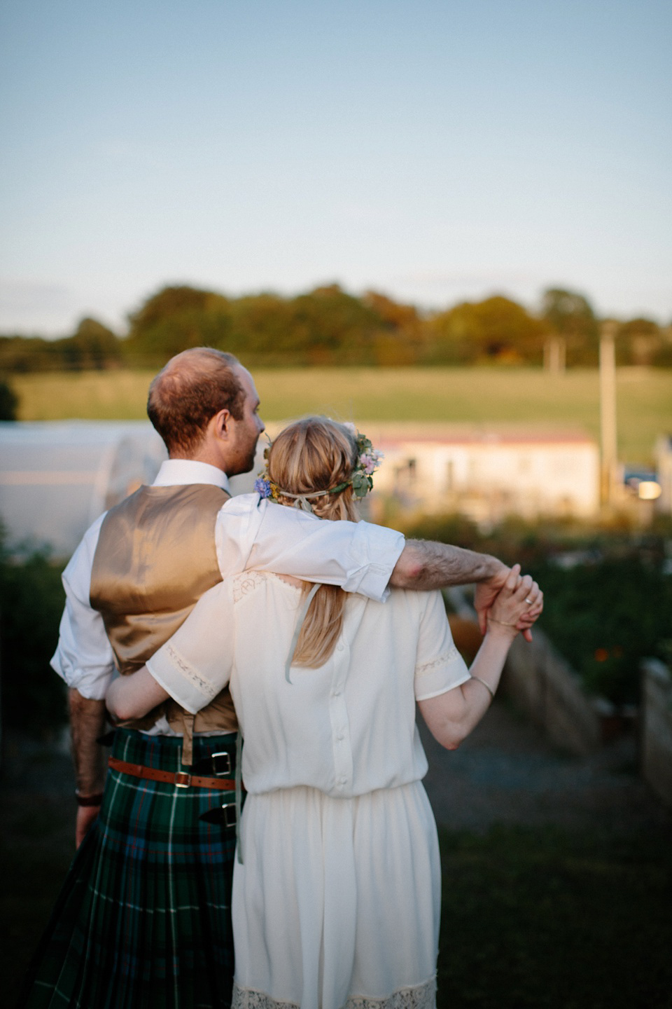 A Humanist handfasting outdoor ceremony at The Secret Herb Garden, just outside Edinburgh. The bride wore 'Minna'. Photography by Caro Weiss.