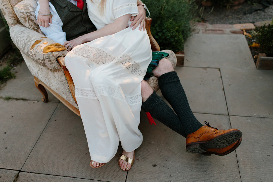 A Humanist handfasting outdoor ceremony at The Secret Herb Garden, just outside Edinburgh. The bride wore 'Minna'. Photography by Caro Weiss.