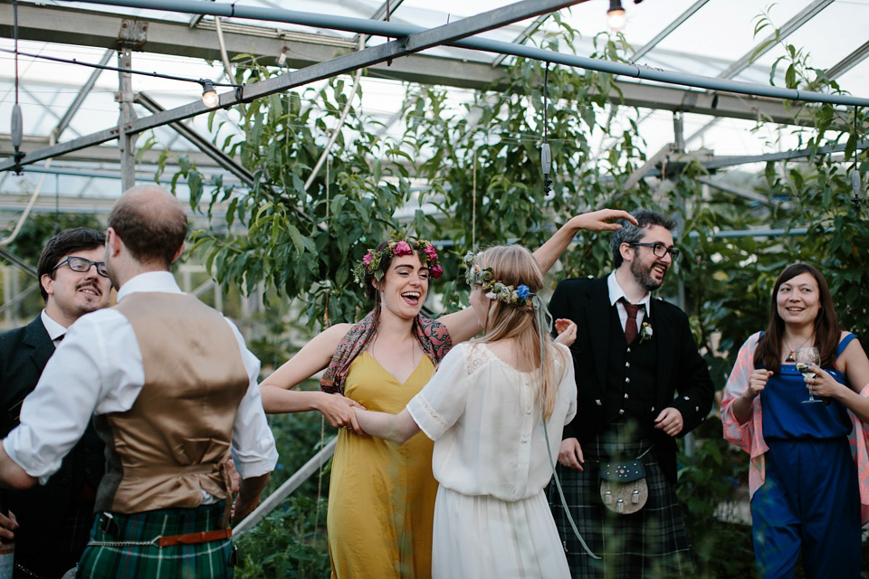 A Humanist handfasting outdoor ceremony at The Secret Herb Garden, just outside Edinburgh. The bride wore 'Minna'. Photography by Caro Weiss.