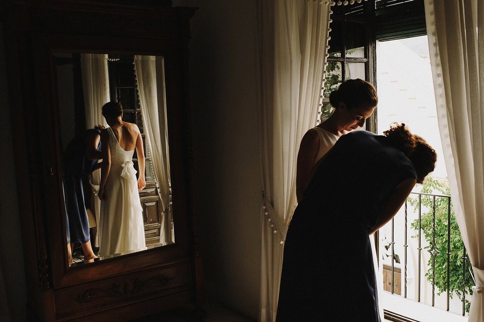 A sophisticated asymmetric dress and sweet first look for a colourful outdoor wedding in Spain. Photography by This Modern Love.