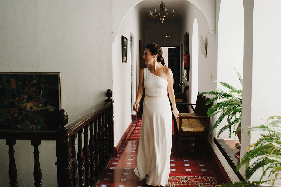 A sophisticated asymmetric dress and sweet first look for a colourful outdoor wedding in Spain. Photography by This Modern Love.