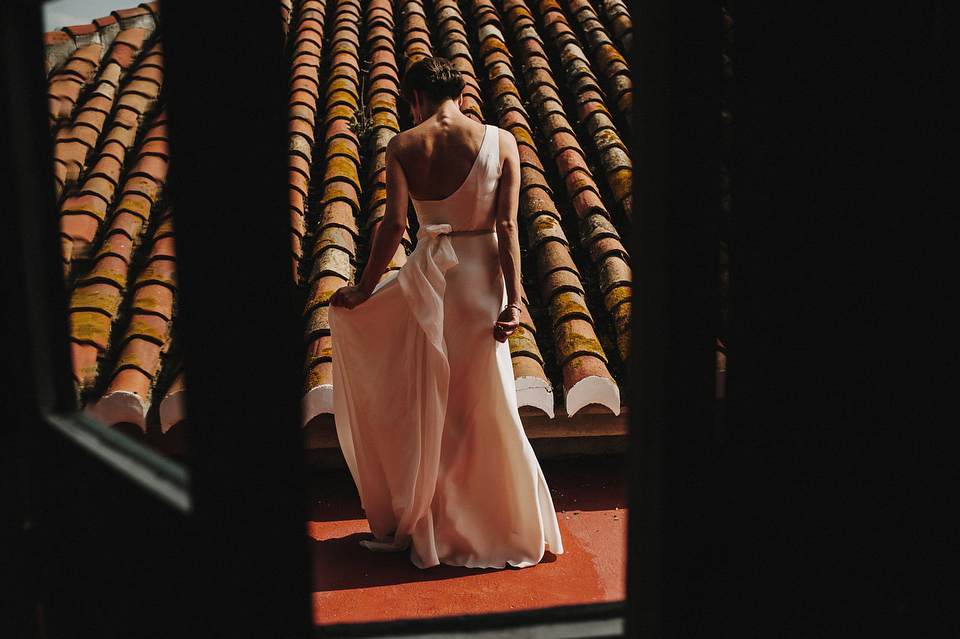 A sophisticated asymmetric dress and sweet first look for a colourful outdoor wedding in Spain. Photography by This Modern Love.