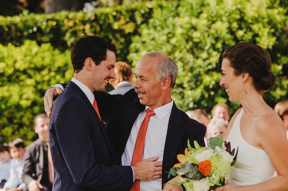 A sophisticated asymmetric dress and sweet first look for a colourful outdoor wedding in Spain. Photography by This Modern Love.