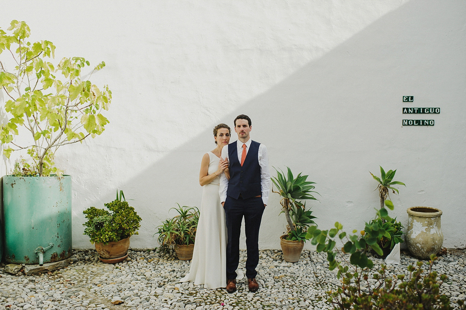 A sophisticated asymmetric dress and sweet first look for a colourful outdoor wedding in Spain. Photography by This Modern Love.