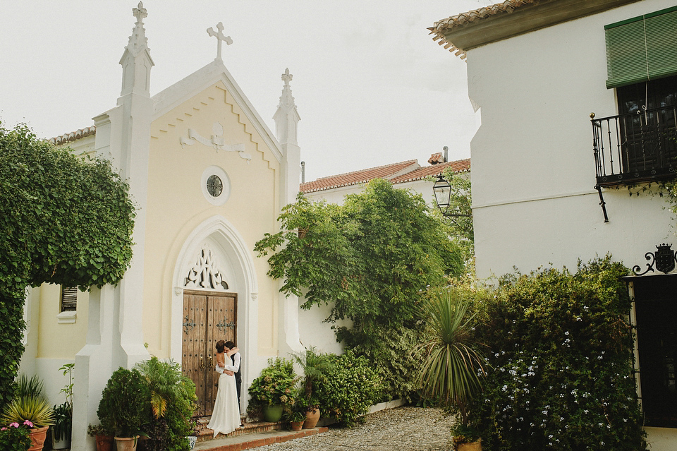 A sophisticated asymmetric dress and sweet first look for a colourful outdoor wedding in Spain. Photography by This Modern Love.