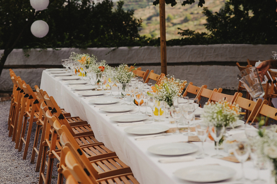 A sophisticated asymmetric dress and sweet first look for a colourful outdoor wedding in Spain. Photography by This Modern Love.