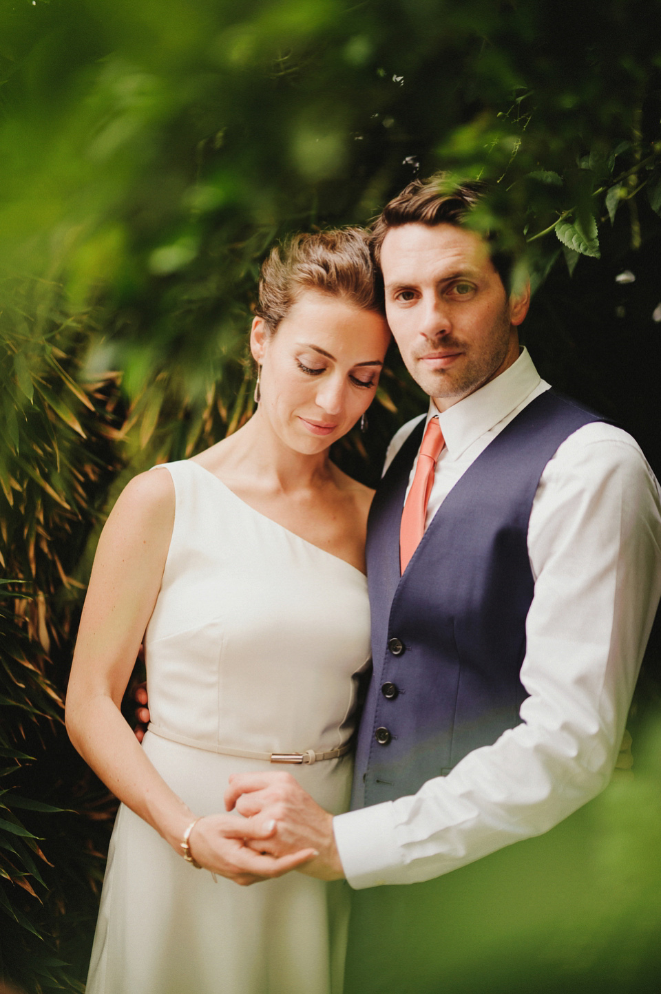 A sophisticated asymmetric dress and sweet first look for a colourful outdoor wedding in Spain. Photography by This Modern Love.