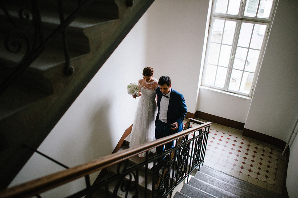 An elegant wedding in Croatia with a bride wearing a dress covered in silk petals and a pug dog in a red bow tie. Photography by Marko Marinkovic.