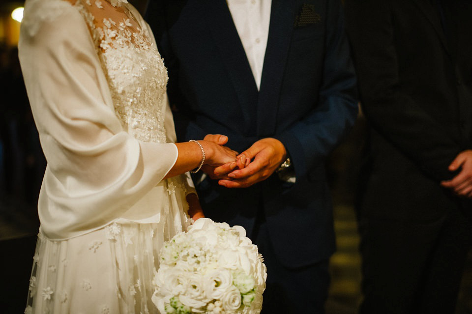 An elegant wedding in Croatia with a bride wearing a dress covered in silk petals and a pug dog in a red bow tie. Photography by Marko Marinkovic.